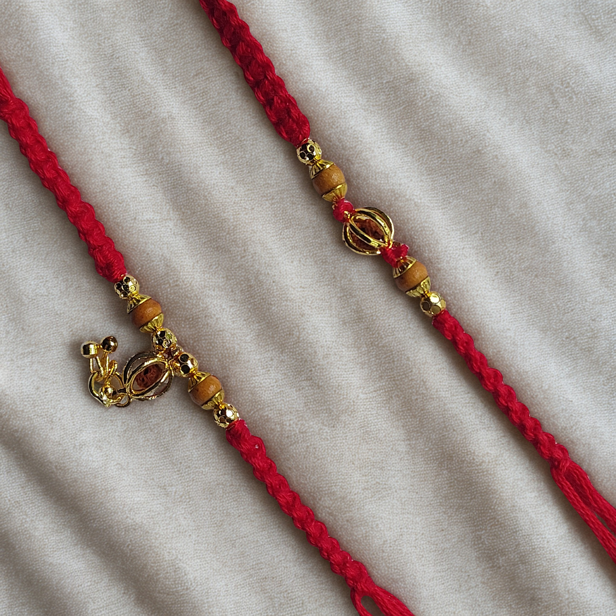 Elegant Gold Charm Bhai Bhabhi Rakhi Set